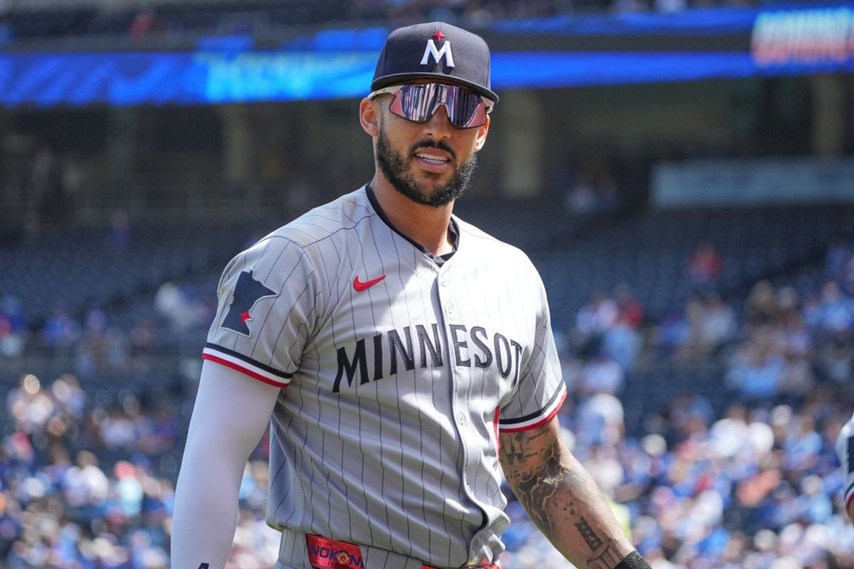 Apr 10, 2025; Kansas City, Missouri, USA; Minnesota Twins second baseman Willi Castro (50) returns to the dugout in between innings against the Kansas City Royals during the game at Kauffman Stadium. Mandatory Credit: Denny Medley-Imagn Images