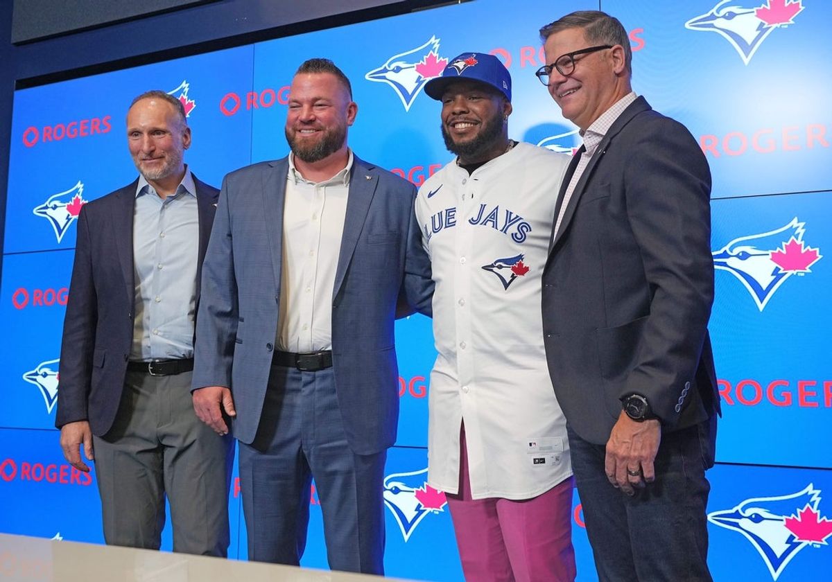 Apr 14, 2025; Toronto, Ontario, Canada; From left to right Toronto Blue Jays President and CEO Mark Shapiro and manager John Schneider and Vladimir Guerrero Jr. and general manager Ross Atkins pose for a photo during the press conference at Rogers Centre. Mandatory Credit: Nick Turchiaro-Imagn Images