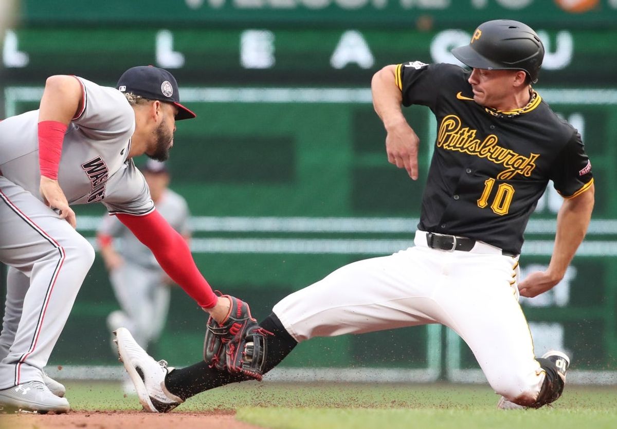 Apr 14, 2025; Pittsburgh, Pennsylvania, USA;  Washington Nationals second baseman Luis Garcia Jr. (2) tags Pittsburgh Pirates designated hitter Bryan Reynolds (10) out at second base on a steal attempt during the third inning at PNC Park. Mandatory Credit: Charles LeClaire-Imagn Images