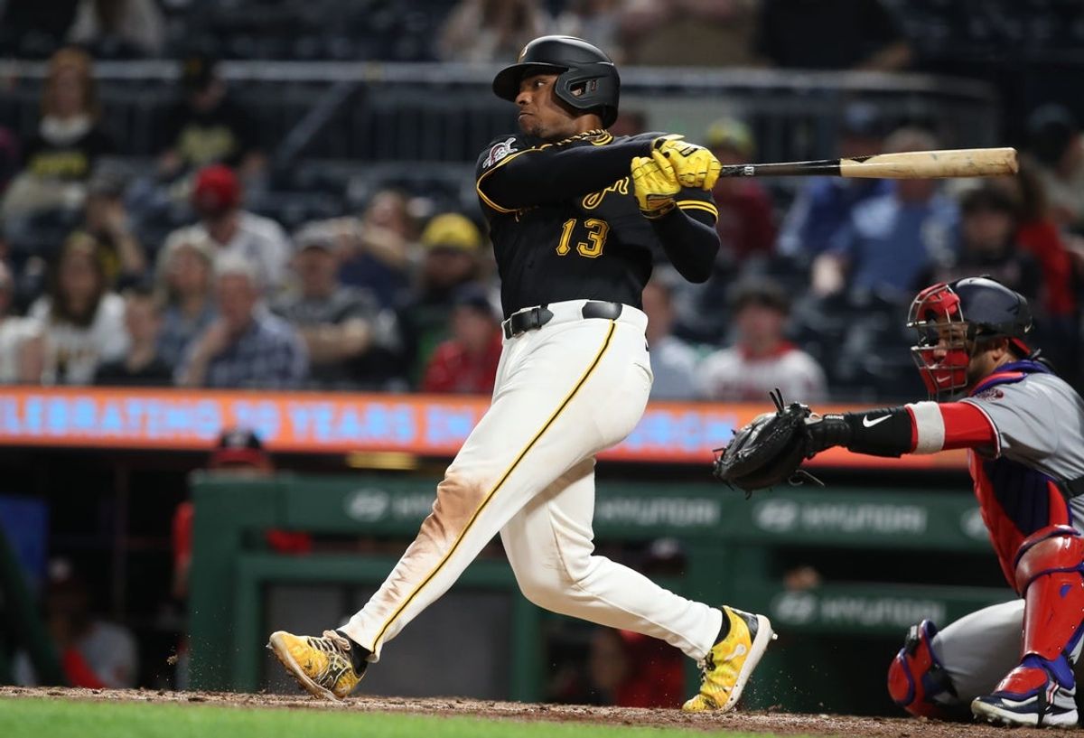 Apr 14, 2025; Pittsburgh, Pennsylvania, USA; Pittsburgh Pirates third baseman Ke'Bryan Hayes (13) hits an RBI single against the the Washington Nationals during the eighth inning at PNC Park. Mandatory Credit: Charles LeClaire-Imagn Images