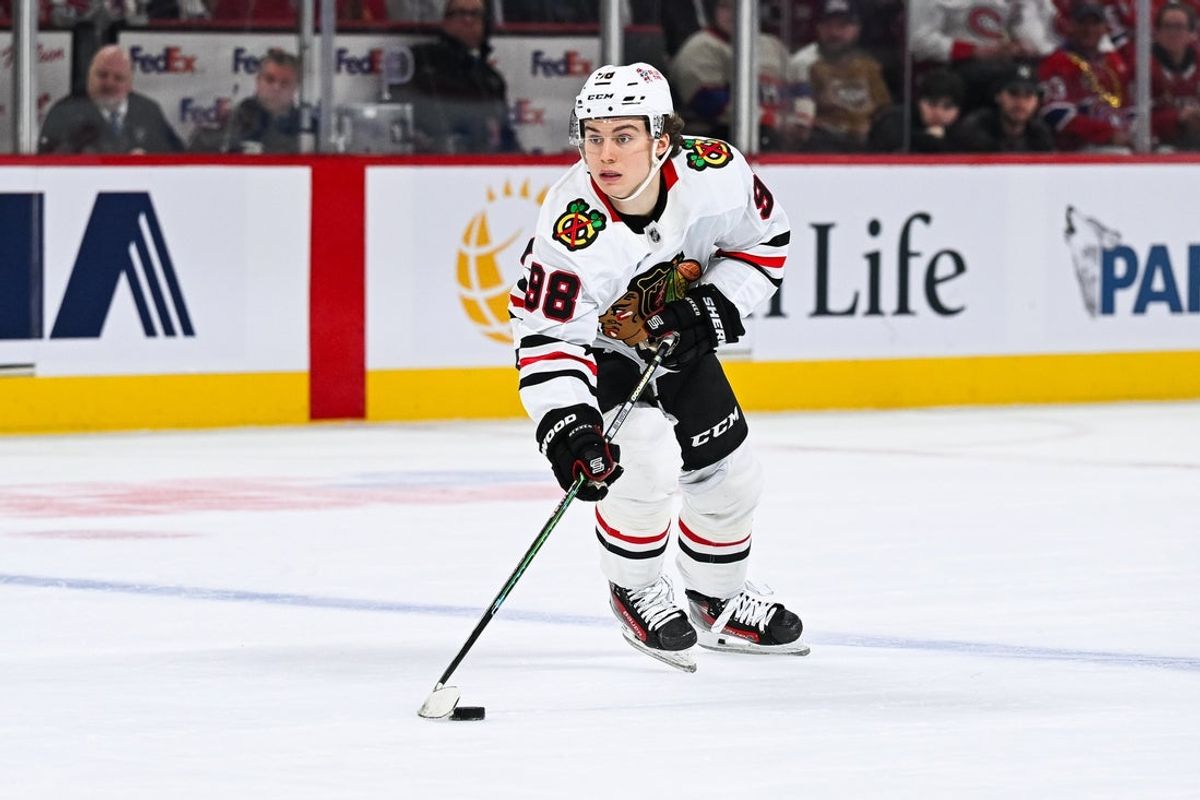 Apr 14, 2025; Montreal, Quebec, CAN; Chicago Blackhawks center Connor Bedard (98) plays the puck against the Montreal Canadiens in the third period at Bell Centre. Mandatory Credit: David Kirouac-Imagn Images