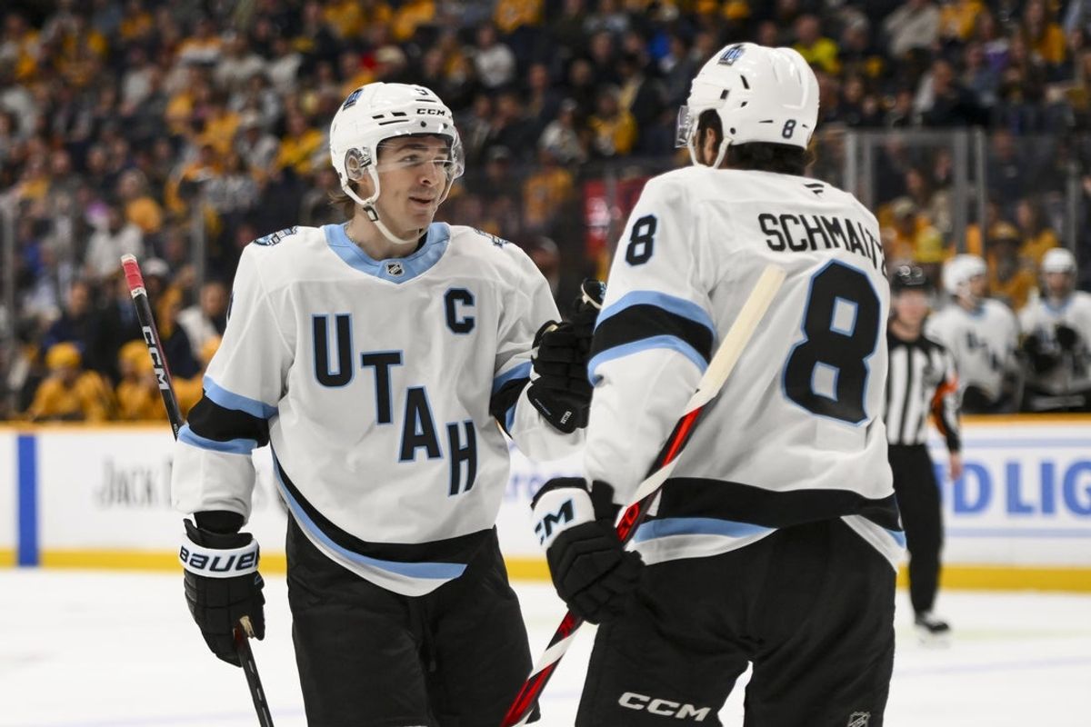 Apr 14, 2025; Nashville, Tennessee, USA;  Utah Hockey Club center Nick Schmaltz (8) celebrates a goal with center Clayton Keller (9) against the Nashville Predators during the second period at Bridgestone Arena. Mandatory Credit: Steve Roberts-Imagn Images