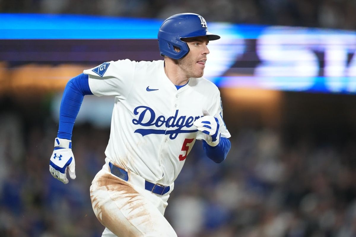 Apr 14, 2025; Los Angeles, California, USA;  Los Angeles Dodgers first baseman Freddie Freeman (5) singles in the first inning against the Colorado Rockies at Dodger Stadium. Mandatory Credit: Kirby Lee-Imagn Images