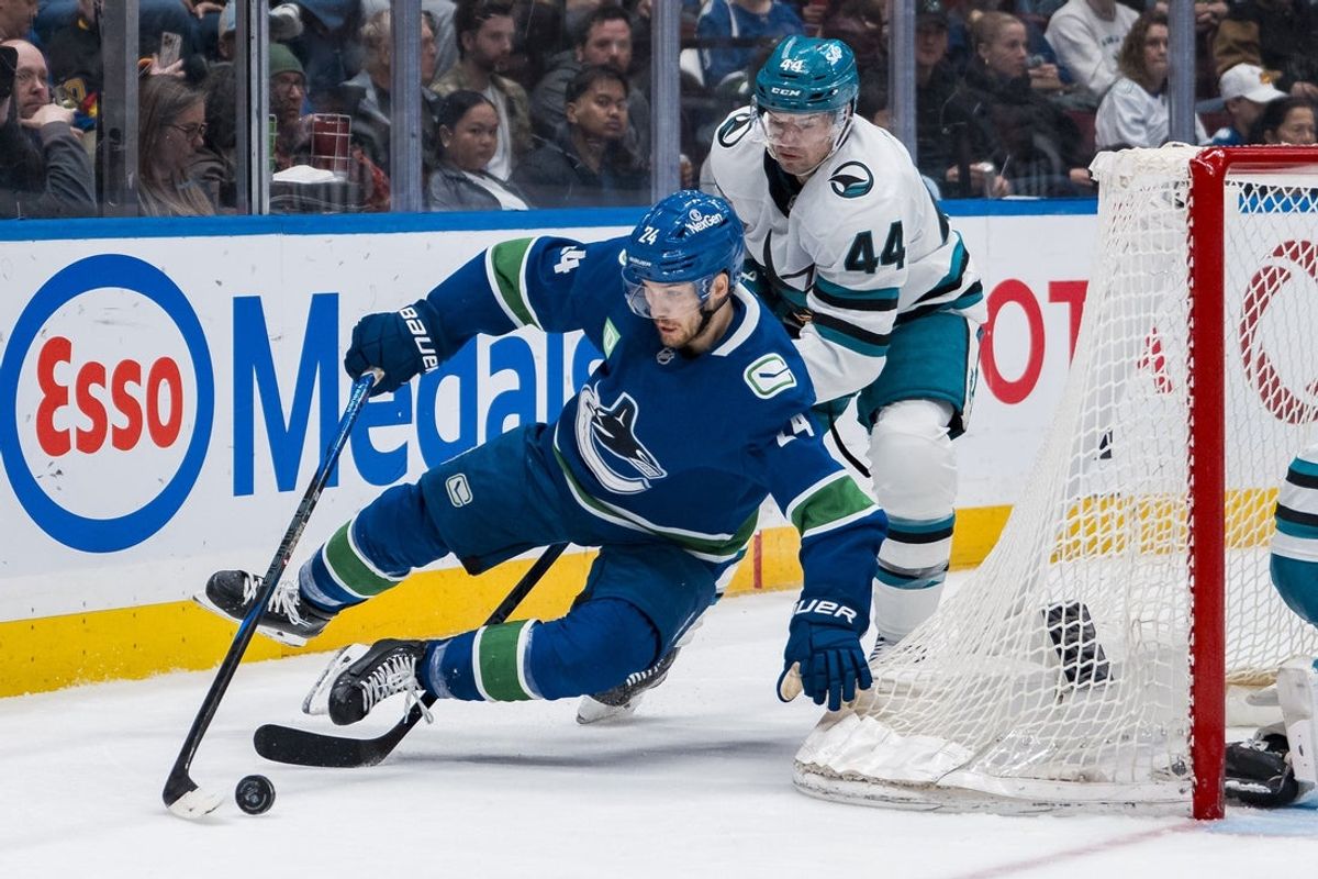 Apr 14, 2025; Vancouver, British Columbia, CAN; San Jose Sharks defenseman Marc Edouard Vlasic (44) checks Vancouver Canucks forward Pius Suter (24) in the second period at Rogers Arena. Mandatory Credit: Bob Frid-Imagn Images