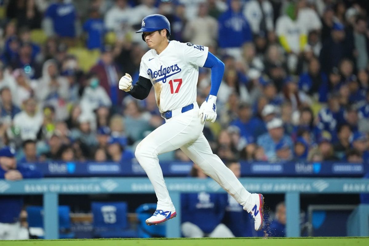 Apr 14, 2025; Los Angeles, California, USA;  Los Angeles Dodgers designated hitter Shohei Ohtani (17) scores on a sacrifice fly in the bottom of the sixth inning against the Colorado Rockies at Dodger Stadium. Mandatory Credit: Kirby Lee-Imagn Images