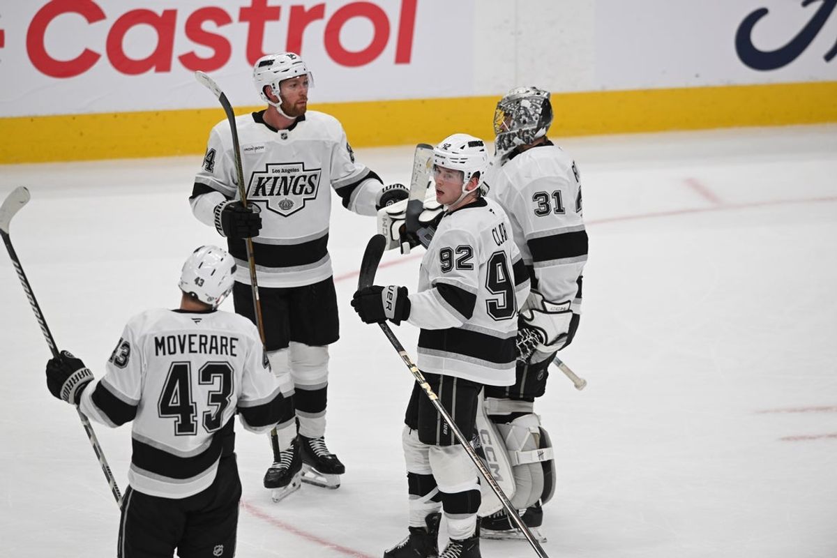 Apr 14, 2025; Edmonton, Alberta, CAN; Los Angeles Kings defenceman Vladislav Gavrikov (84) and defenceman Brandt Clarke (92) celebrate their win with goaltender Darcy Kuemper (35) against the Edmonton Oilers at the end of the third period at Rogers Place. Mandatory Credit: Walter Tychnowicz-Imagn Images