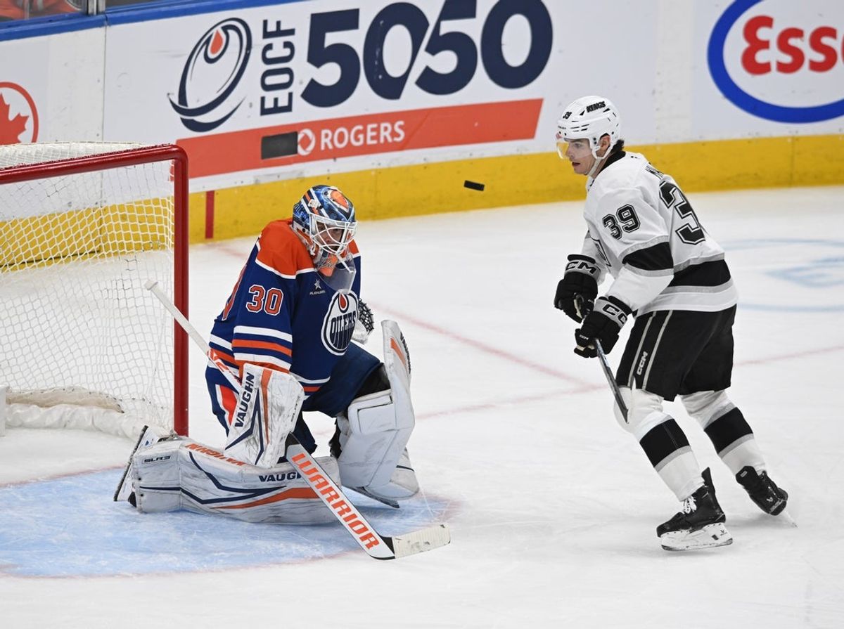 Apr 14, 2025; Edmonton, Alberta, CAN; Edmonton Oilers goalie Calvin Pickard (30) stops a puck as Los Angeles Kings left winger Jeff Malott (39) looks on during the third period at Rogers Place. Mandatory Credit: Walter Tychnowicz-Imagn Images