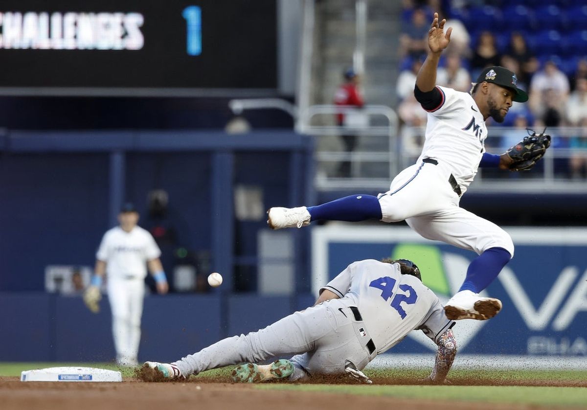 Apr 15, 2025; Miami, Florida, USA;  Arizona Diamondbacks center fielder Alek Thomas (5) steals second under Miami Marlins second baseman Otto Lopez (6) during the second inning at loanDepot Park. All players wore #42 for Jackie Robinson Day.Mandatory Credit: Rhona Wise-Imagn Images