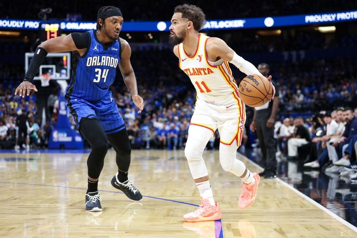 Apr 15, 2025; Orlando, Florida, USA; Atlanta Hawks guard Trae Young (11) controls the ball from Orlando Magic center Wendell Carter Jr. (34) in the first quarter at Kia Center. Mandatory Credit: Nathan Ray Seebeck-Imagn Images