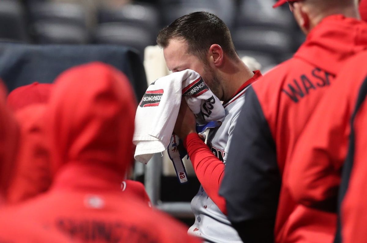 Apr 15, 2025; Pittsburgh, Pennsylvania, USA;  Washington Nationals third baseman Paul DeJong (14) heads into the clubhouse after being hit in the face by a Pittsburgh Pirates pitch during the sixth inning at PNC Park. Mandatory Credit: Charles LeClaire-Imagn Images