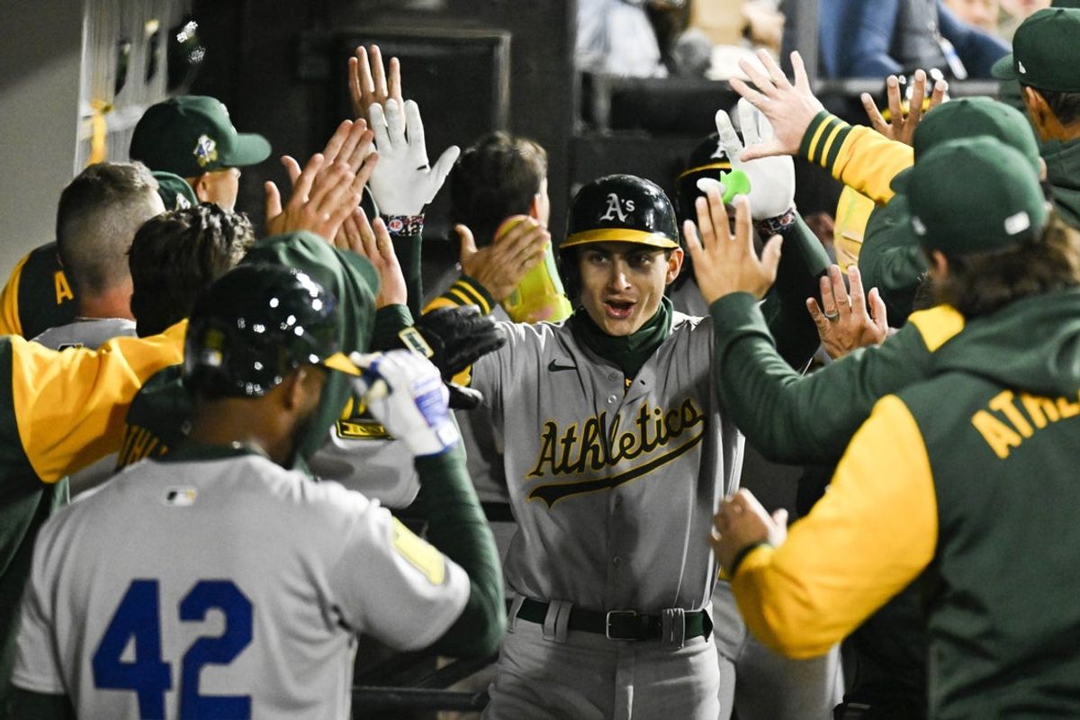 Apr 15, 2025; Chicago, Illinois, USA;  Athletics first baseman Tyler Soderstrom (21) celebrates in the dugout after  his  three run home run against the Chicago White Sox  during the sixth inning at Rate Field.  “All players wore #42 for Jackie Robinson Day” Mandatory Credit: Matt Marton-Imagn Images.
