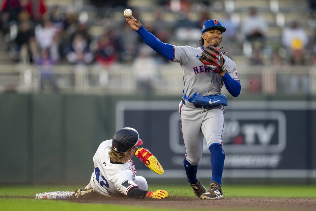 Apr 15, 2025; Minneapolis, Minnesota, USA; New York Mets shortstop Francisco Lindor (12) forces out Minnesota Twins left fielder Harrison Bader (12) at second base and throws the ball to first base for a double play in the fourth inning at Target Field. All players wore #42 for Jackie Robinson Day Mandatory Credit: Jesse Johnson-Imagn Images