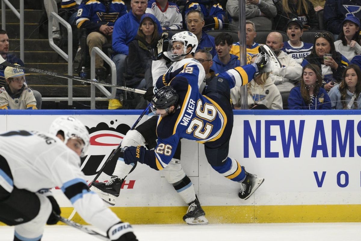 Apr 15, 2025; St. Louis, Missouri, USA; St. Louis Blues left wing Nathan Walker (26) checks Utah Hockey Club right wing Dylan Guenther (11) during the second period at Enterprise Center. Mandatory Credit: Jeff Le-Imagn Images
