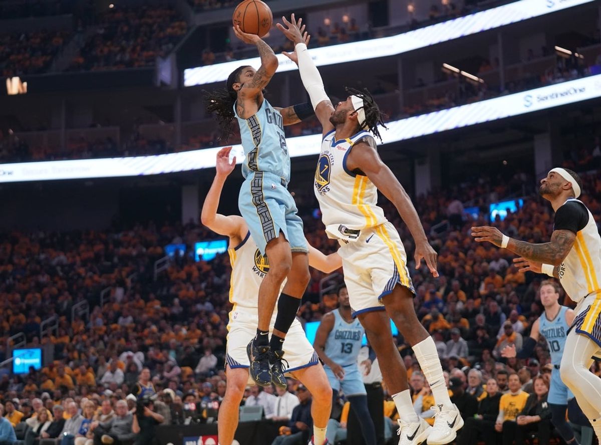 Apr 15, 2025; San Francisco, California, USA; Memphis Grizzlies guard Ja Morant (12) shoots over Golden State Warriors guard Buddy Hield (7) in the first quarter at the Chase Center. Mandatory Credit: Cary Edmondson-Imagn Images