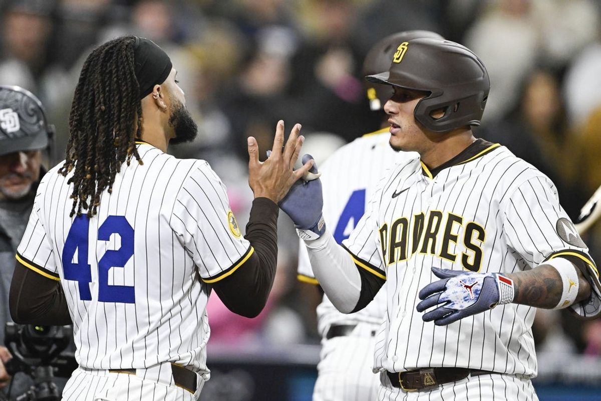 Apr 15, 2025; San Diego, California, USA; San Diego Padres third baseman Manny Machado (13), right, is congratulated by Fernando Tatis Jr. (23) after hitting a solo home run during the fifth inning against the Chicago Cubs at Petco Park. Mandatory Credit: Denis Poroy-Imagn Images