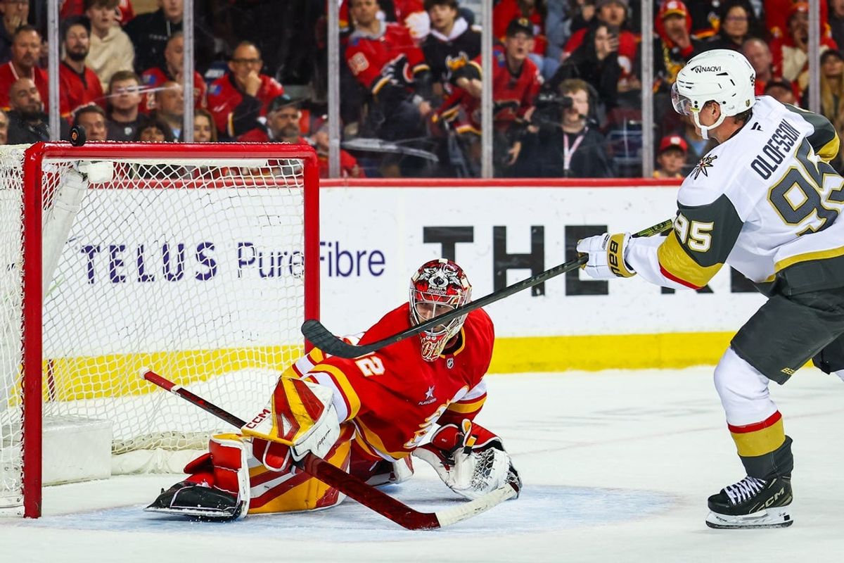 Apr 15, 2025; Calgary, Alberta, CAN; Vegas Golden Knights right wing Victor Olofsson (95) hits the crossbar against Calgary Flames goaltender Dustin Wolf (32) during the shootout period at Scotiabank Saddledome. Mandatory Credit: Sergei Belski-Imagn Images