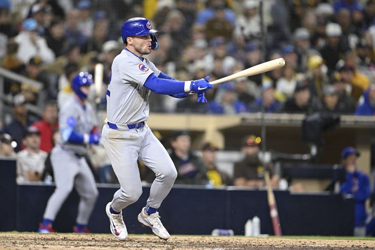 Apr 15, 2025; San Diego, California, USA; Chicago Cubs second baseman Nico Hoerner (2) hits an RBI triple during the tenth inning against the San Diego Padres at Petco Park. Mandatory Credit: Denis Poroy-Imagn Images