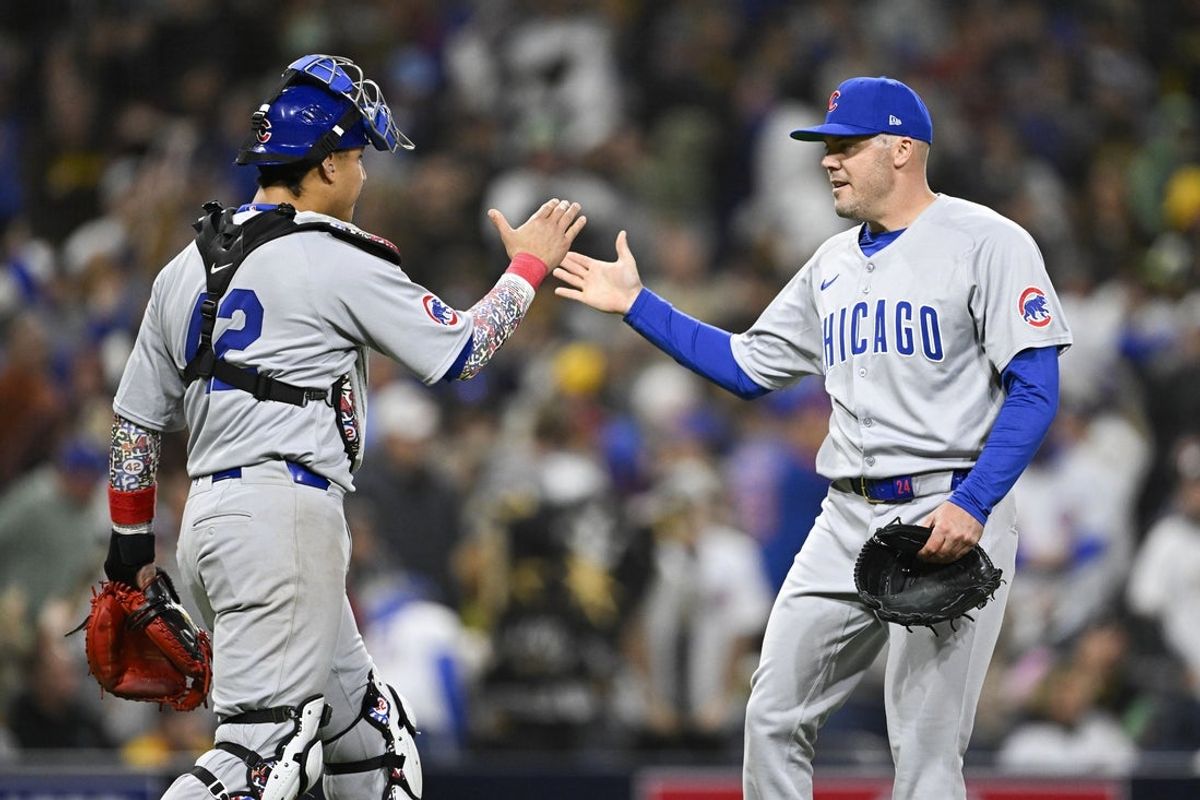 Apr 15, 2025; San Diego, California, USA; Chicago Cubs relief pitcher Caleb Thielbar (24) is congratulated by Miguel Amaya (9) after the Cubs beat the San Diego Padres 2-1 at Petco Park. Mandatory Credit: Denis Poroy-Imagn Images