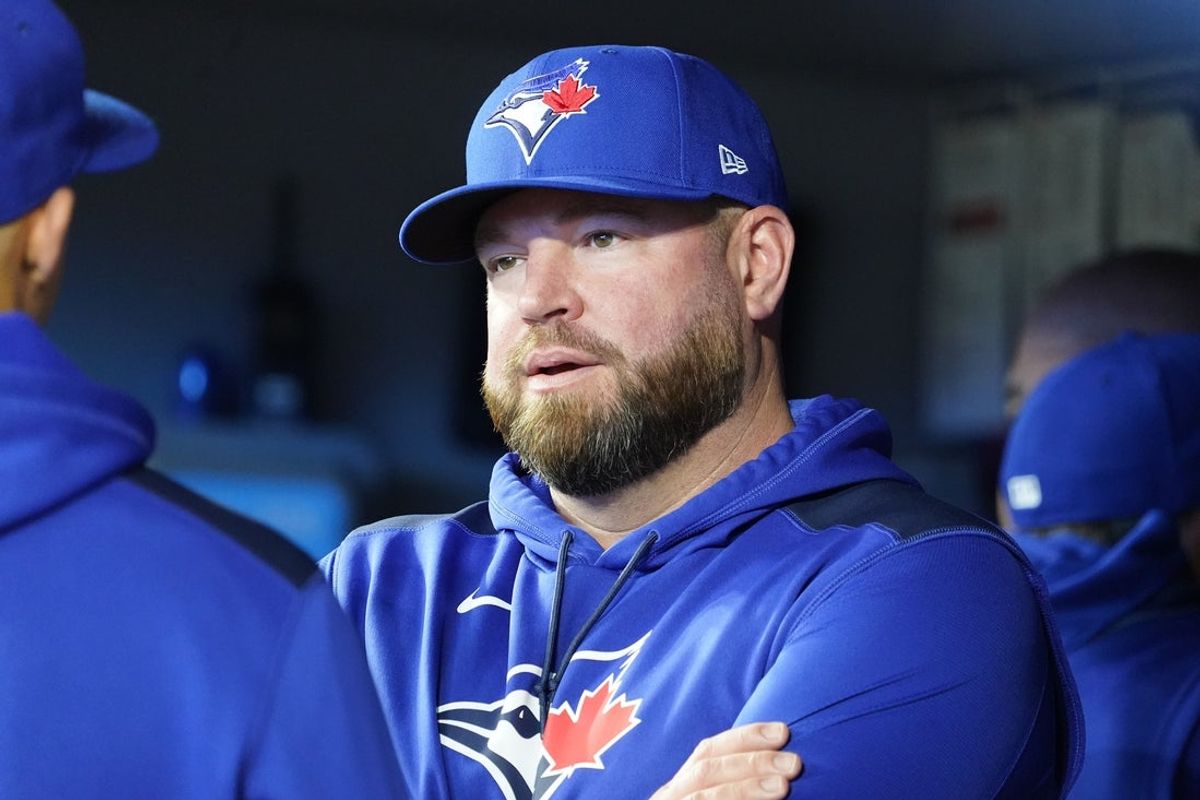 Apr 16, 2025; Toronto, Ontario, CAN; Toronto Blue Jays manager John Schneider talks with one of his assistant coaches before the start of the game against the Atlanta Braves at Rogers Centre. Mandatory Credit: John E. Sokolowski-Imagn Images