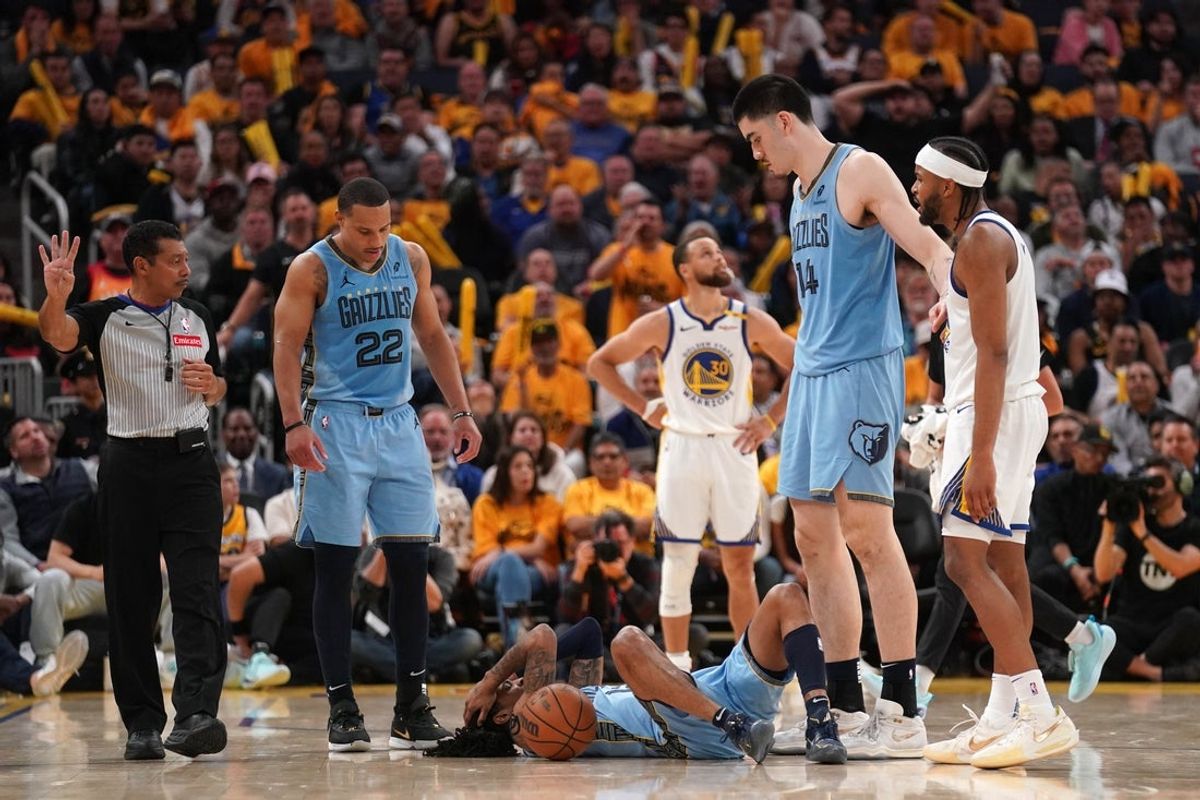 Apr 15, 2025; San Francisco, California, USA; Memphis Grizzlies guard Ja Morant (12) lays on the ground after being fouled against the Golden State Warriors in the fourth quarter at the Chase Center. Mandatory Credit: Cary Edmondson-Imagn Images