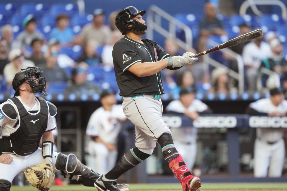 Apr 16, 2025; Miami, Florida, USA;  Arizona Diamondbacks first baseman Josh Naylor (22) watches his home run leave the park against the Miami Marlins in the second inning at loanDepot Park. Mandatory Credit: Jim Rassol-Imagn Images