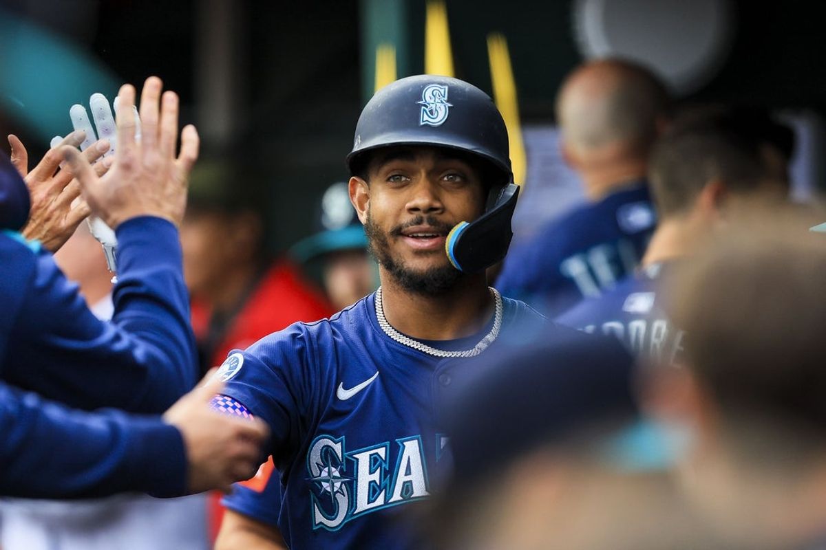 Apr 16, 2025; Cincinnati, Ohio, USA; Seattle Mariners outfielder Julio Rodriguez (44) high fives teammates after scoring on a RBI double hit by outfielder Randy Arozarena (not pictured) in the first inning against the Cincinnati Reds at Great American Ball Park. Mandatory Credit: Katie Stratman-Imagn Images