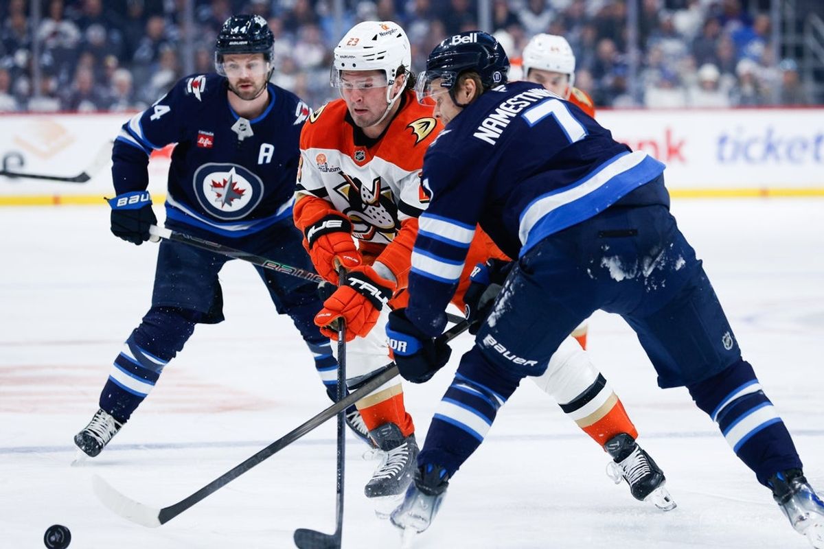 Apr 16, 2025; Winnipeg, Manitoba, CAN;  Winnipeg Jets forward Vladislav Namestnikov (7) checks Anaheim Ducks forward Mason Mctavish (23) during the first period at Canada Life Centre. Mandatory Credit: Terrence Lee-Imagn Images