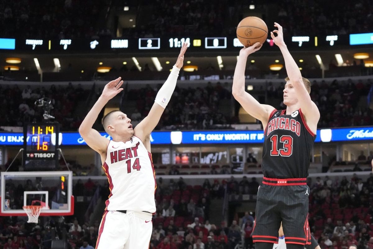 Apr 16, 2025; Chicago, Illinois, USA; Miami Heat guard Tyler Herro (14) defends Chicago Bulls guard Kevin Huerter (13) during the first quarter at United Center. Mandatory Credit: David Banks-Imagn Images