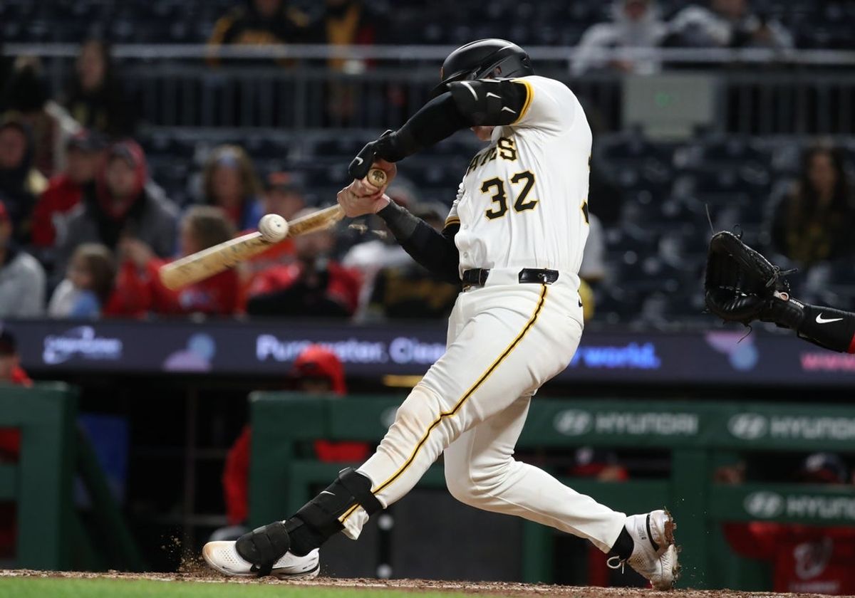 Apr 16, 2025; Pittsburgh, Pennsylvania, USA;  Pittsburgh Pirates catcher Henry Davis (32) drives in a run with a broken bat ground out against the Washington Nationals during the seventh inning at PNC Park. Mandatory Credit: Charles LeClaire-Imagn Images