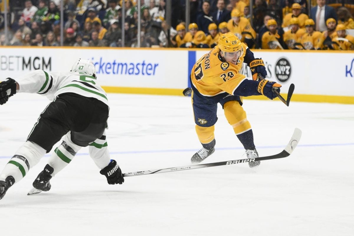 Apr 16, 2025; Nashville, Tennessee, USA;  Dallas Stars defenseman Brendan Smith (2) blocks the shot of Nashville Predators defenseman Justin Barron (20) during the first period at Bridgestone Arena. Mandatory Credit: Steve Roberts-Imagn Images