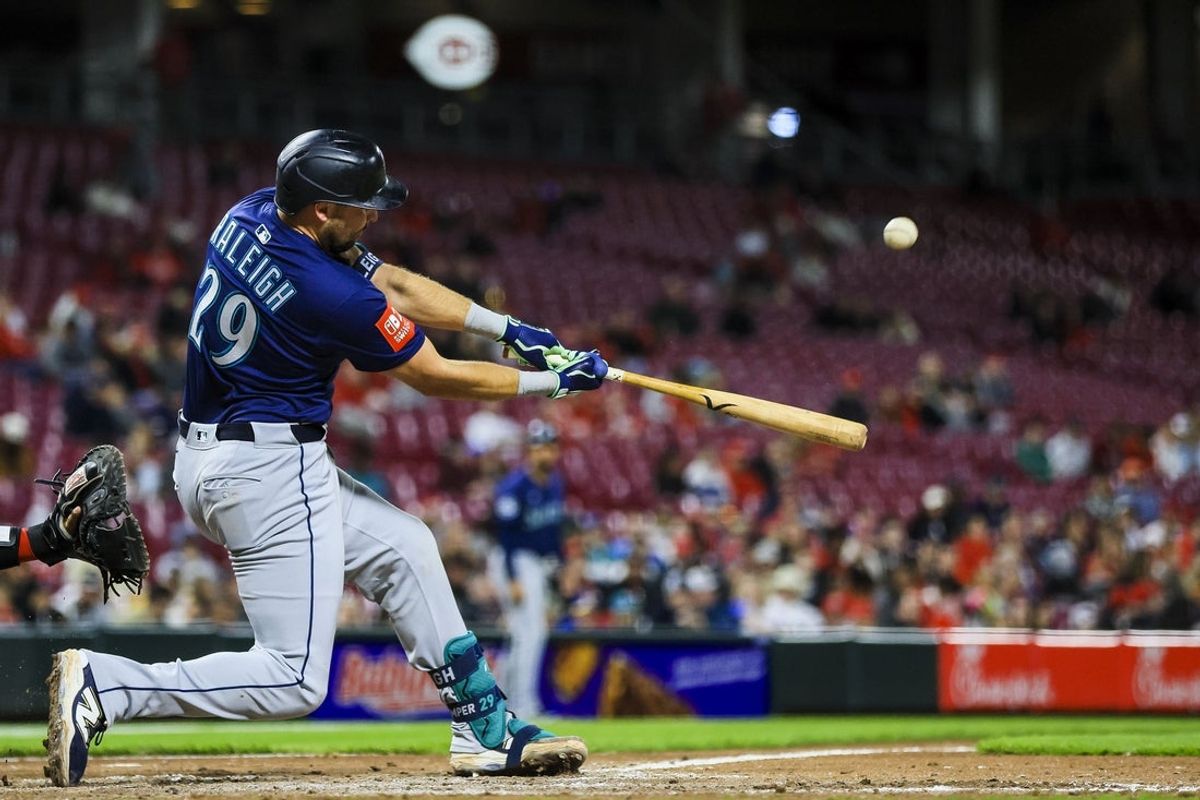 Apr 16, 2025; Cincinnati, Ohio, USA; Seattle Mariners catcher Cal Raleigh (29) hits a solo home run in the seventh inning against the Cincinnati Reds at Great American Ball Park. Mandatory Credit: Katie Stratman-Imagn Images