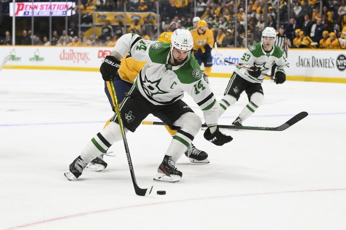 Apr 16, 2025; Nashville, Tennessee, USA;  Dallas Stars left wing Jamie Benn (14) skates with the puck against the Nashville Predators during the second period at Bridgestone Arena. Mandatory Credit: Steve Roberts-Imagn Images