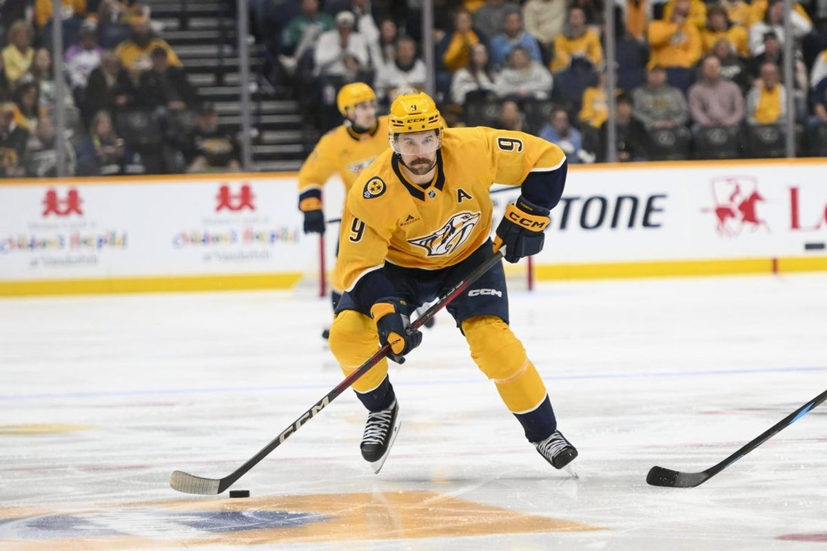 Apr 16, 2025; Nashville, Tennessee, USA;  Nashville Predators left wing Filip Forsberg (9) skates with the puck against the Dallas Stars during the third period at Bridgestone Arena. Mandatory Credit: Steve Roberts-Imagn Images