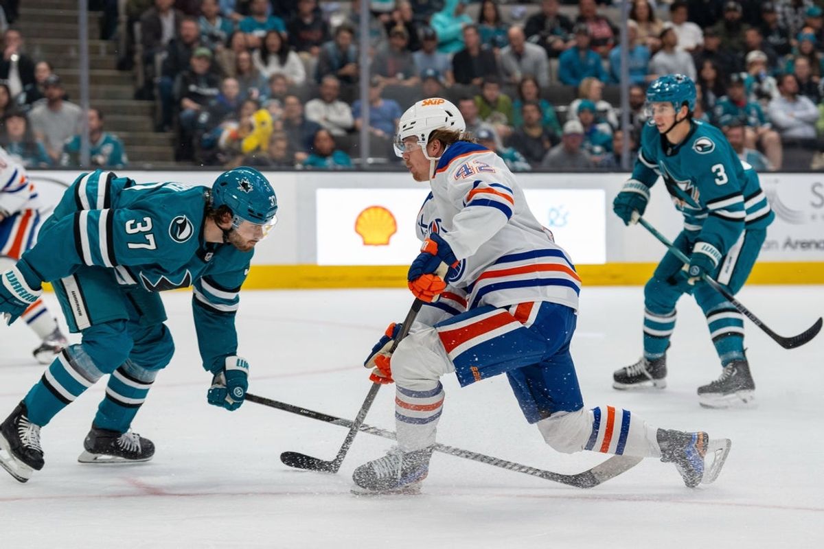 Apr 16, 2025; San Jose, California, USA;  Edmonton Oilers right wing Kasperi Kapanen (42) shoots the puck while being defended by San Jose Sharks defenseman Timothy Liljegren (37) during the first period at SAP Center at San Jose. Mandatory Credit: Neville E. Guard-Imagn Images