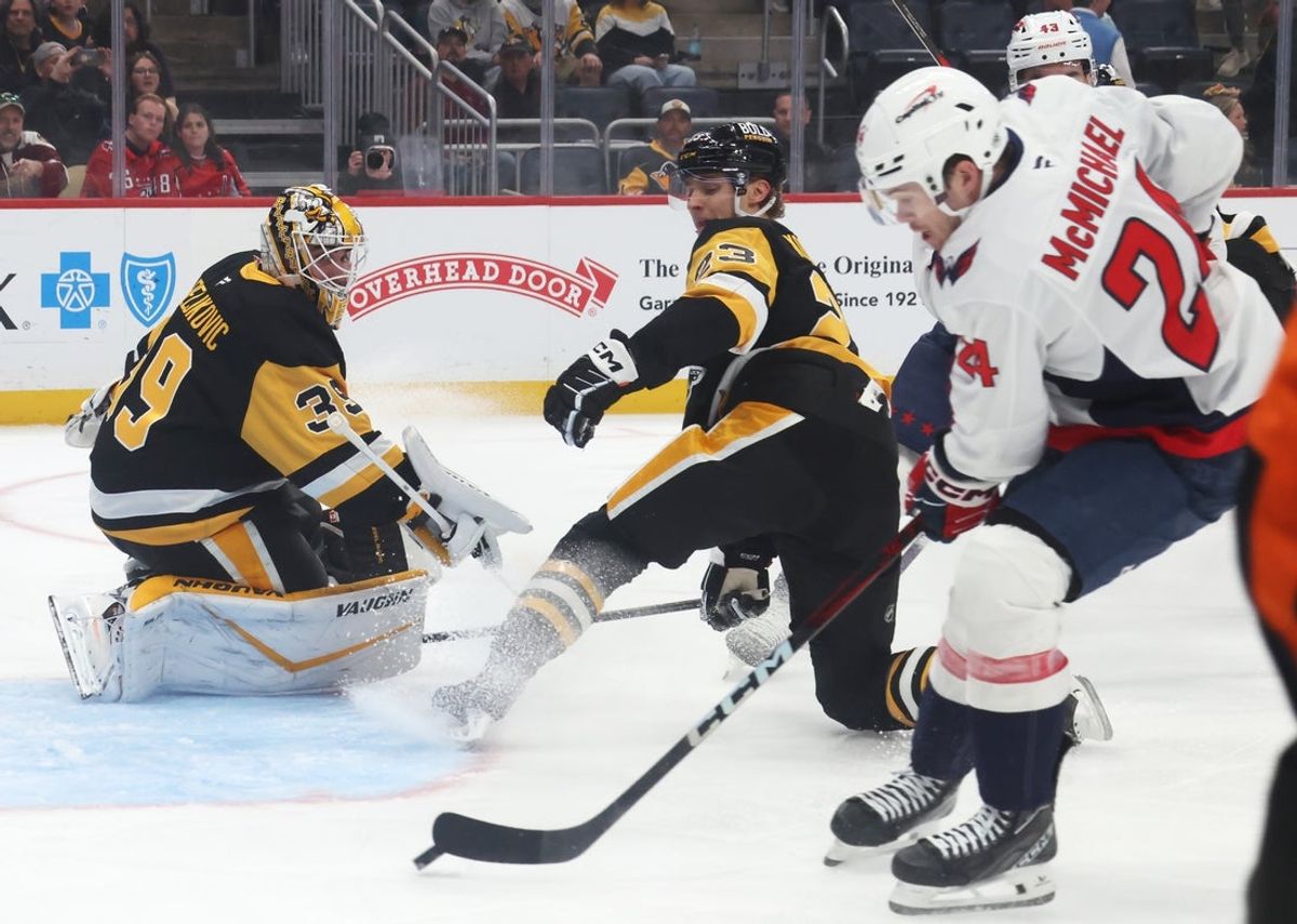 Apr 17, 2025; Pittsburgh, Pennsylvania, USA;  Washington Capitals center Connor McMichael (24) shoots and scores a goal against Pittsburgh Penguins goaltender Alex Nedeljkovic (39) during the first period at PPG Paints Arena. Mandatory Credit: Charles LeClaire-Imagn Images