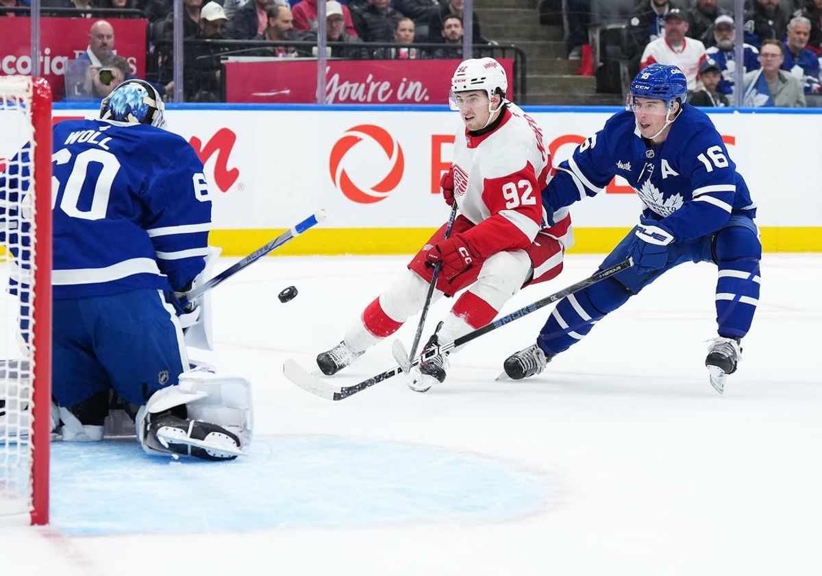 Apr 17, 2025; Toronto, Ontario, CAN; Toronto Maple Leafs right wing Mitch Marner (16) battles for the puck with Detroit Red Wings center Marco Kasper (92) during the second period at Scotiabank Arena. Mandatory Credit: Nick Turchiaro-Imagn Images