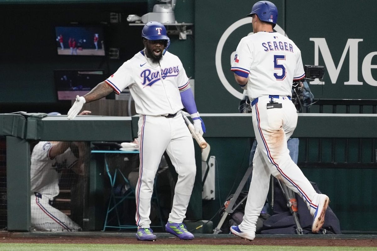 Apr 17, 2025; Arlington, Texas, USA; Texas Rangers shortstop Corey Seager (5) celebrates his solo home run with right fielder Ardolis Garcia (53) against the Los Angeles Angels during the seventh inning at Globe Life Field. Seager’s home run was his 100th as a Texas Ranger. Mandatory Credit: Jim Cowsert-Imagn Images