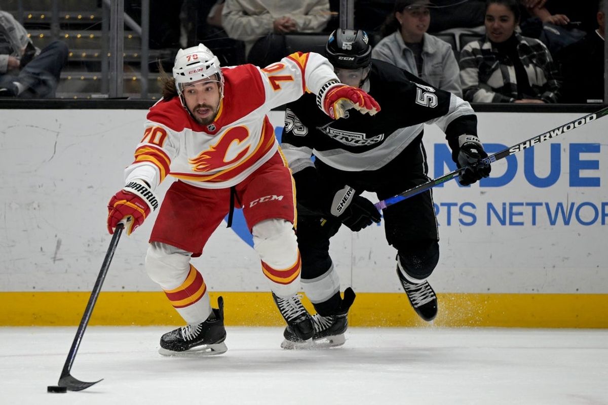 Apr 17, 2025; Los Angeles, California, USA;  Calgary Flames left wing Ryan Lomberg (70) and Los Angeles Kings right wing Quinton Byfield (55) chase down the puck in the first period at Crypto.com Arena. Mandatory Credit: Jayne Kamin-Oncea-Imagn Images