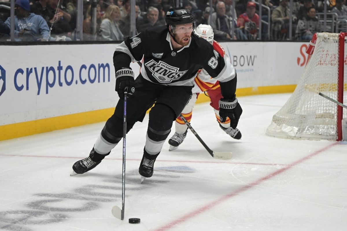 Apr 17, 2025; Los Angeles, California, USA;  Los Angeles Kings defenseman Vladislav Gavrikov (84) controls the puck during the second period at Crypto.com Arena. Mandatory Credit: Jayne Kamin-Oncea-Imagn Images