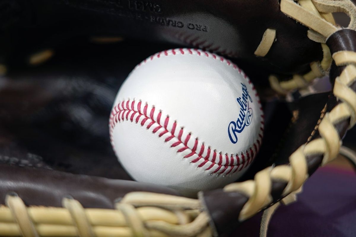 Apr 18, 2025; Milwaukee, Wisconsin, USA;  General view of a baseball in a glove during batting practice prior to the game between the Athletics and Milwaukee Brewers at American Family Field. Mandatory Credit: Jeff Hanisch-Imagn Images