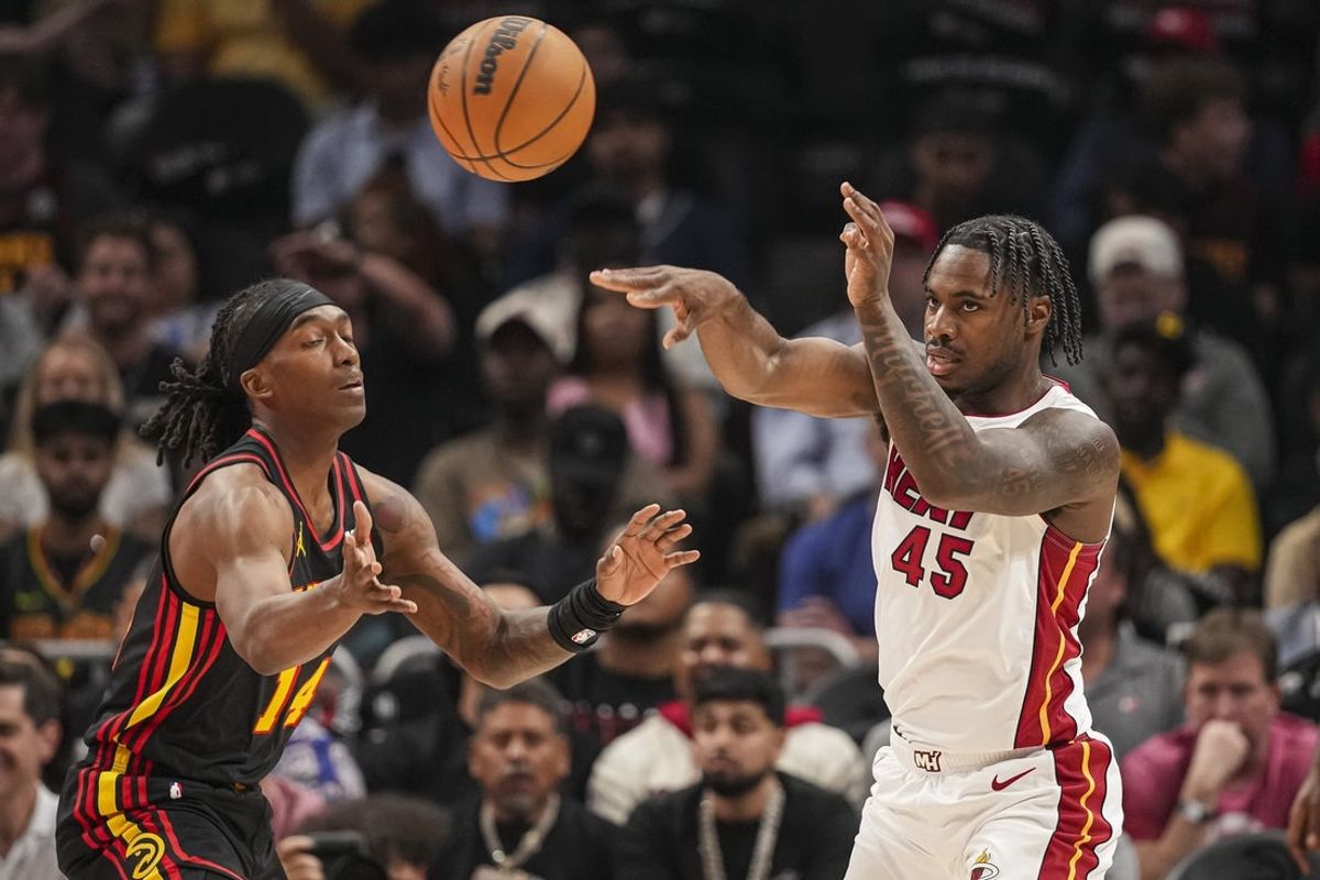Apr 18, 2025; Atlanta, Georgia, USA; Miami Heat guard Davion Mitchell (45) passes past during the first half at State Farm Arena. Mandatory Credit: Dale Zanine-Imagn Images