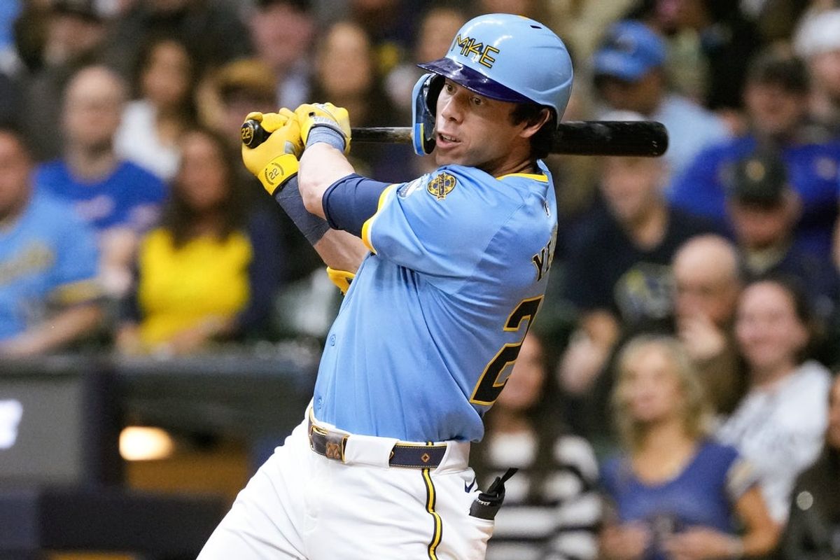 Apr 18, 2025; Milwaukee, Wisconsin, USA;  Milwaukee Brewers designated hitter Christian Yelich (22) hits an RBI single during the third inning against the Athletics at American Family Field. Mandatory Credit: Jeff Hanisch-Imagn Images