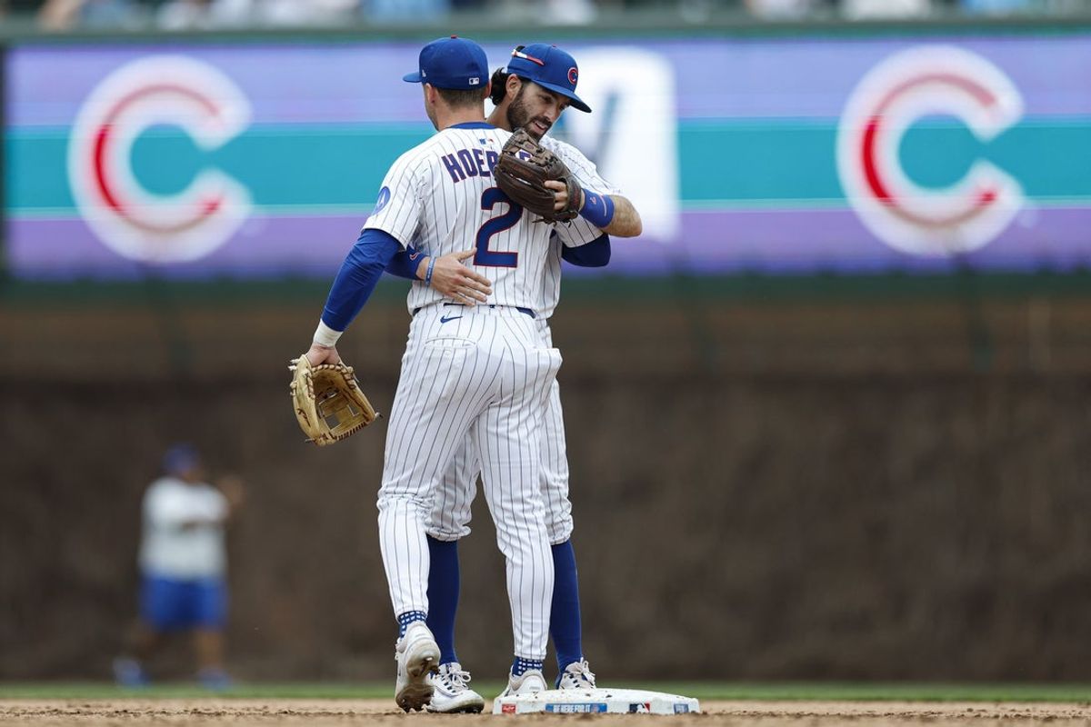 Apr 18, 2025; Chicago, Illinois, USA; Chicago Cubs shortstop Dansby Swanson (7) and second baseman Nico Hoerner (2) celebrate after defeating the Arizona Diamondbacks at Wrigley Field. Mandatory Credit: Kamil Krzaczynski-Imagn Images