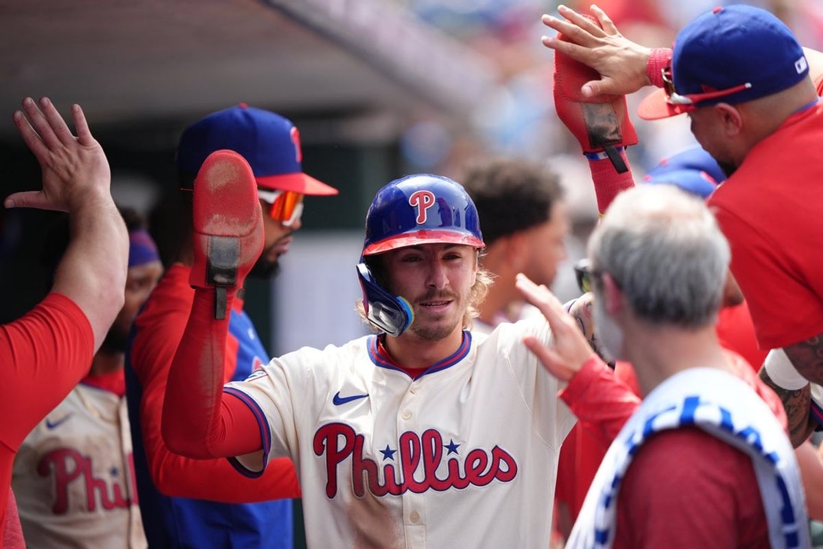 Apr 19, 2025; Philadelphia, Pennsylvania, USA; Philadelphia Phillies infielder Bryson Stott (5) celebrates with teammates after scoring against the Miami Marlins in the fourth inning at Citizens Bank Park. Mandatory Credit: Kyle Ross-Imagn Images