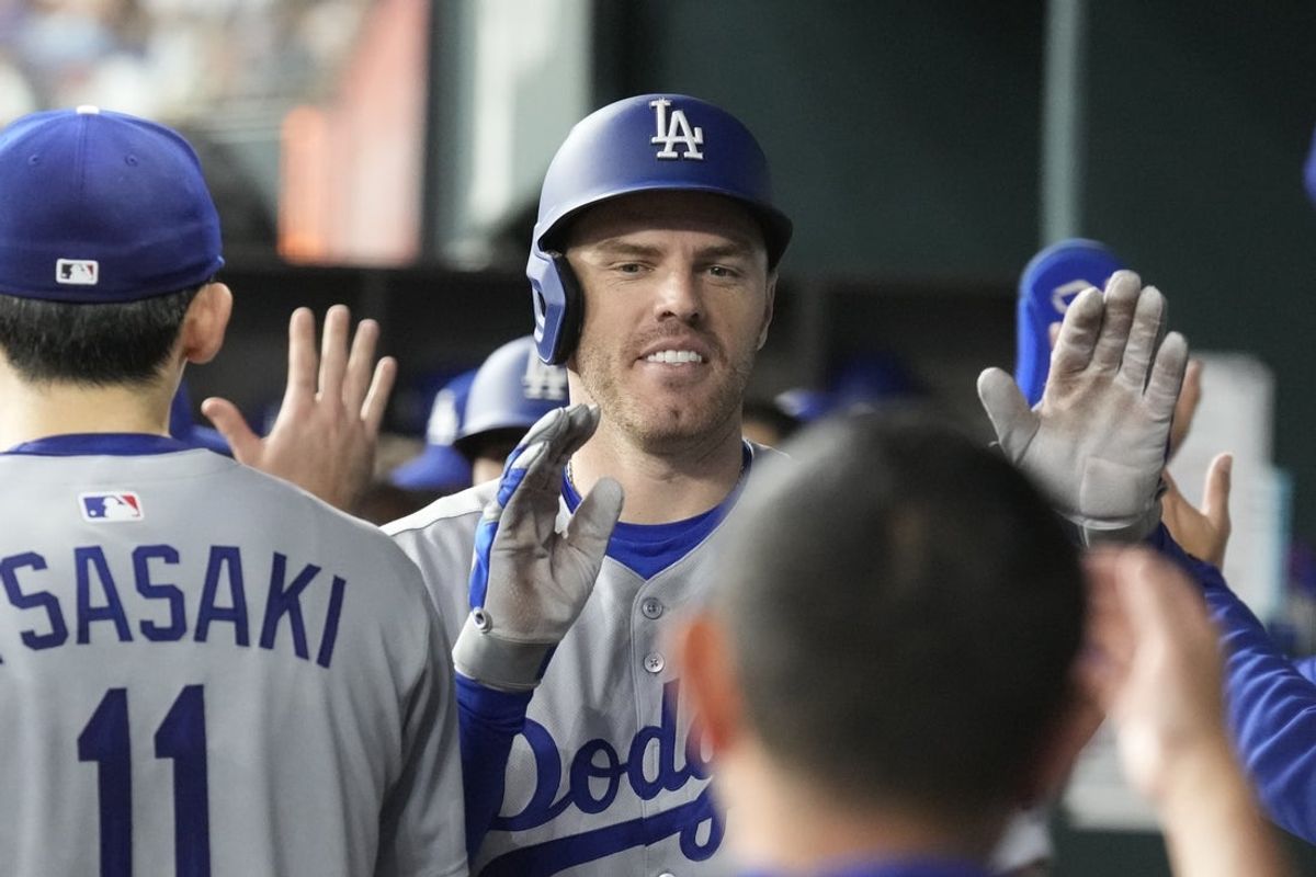 Apr 19, 2025; Arlington, Texas, USA; Los Angeles Dodgers first baseman Freddie Freeman (5) celebrates his two-run home run with teammates in the dugout during the fourth inning against the Texas Rangers at Globe Life Field. Mandatory Credit: Jim Cowsert-Imagn Images