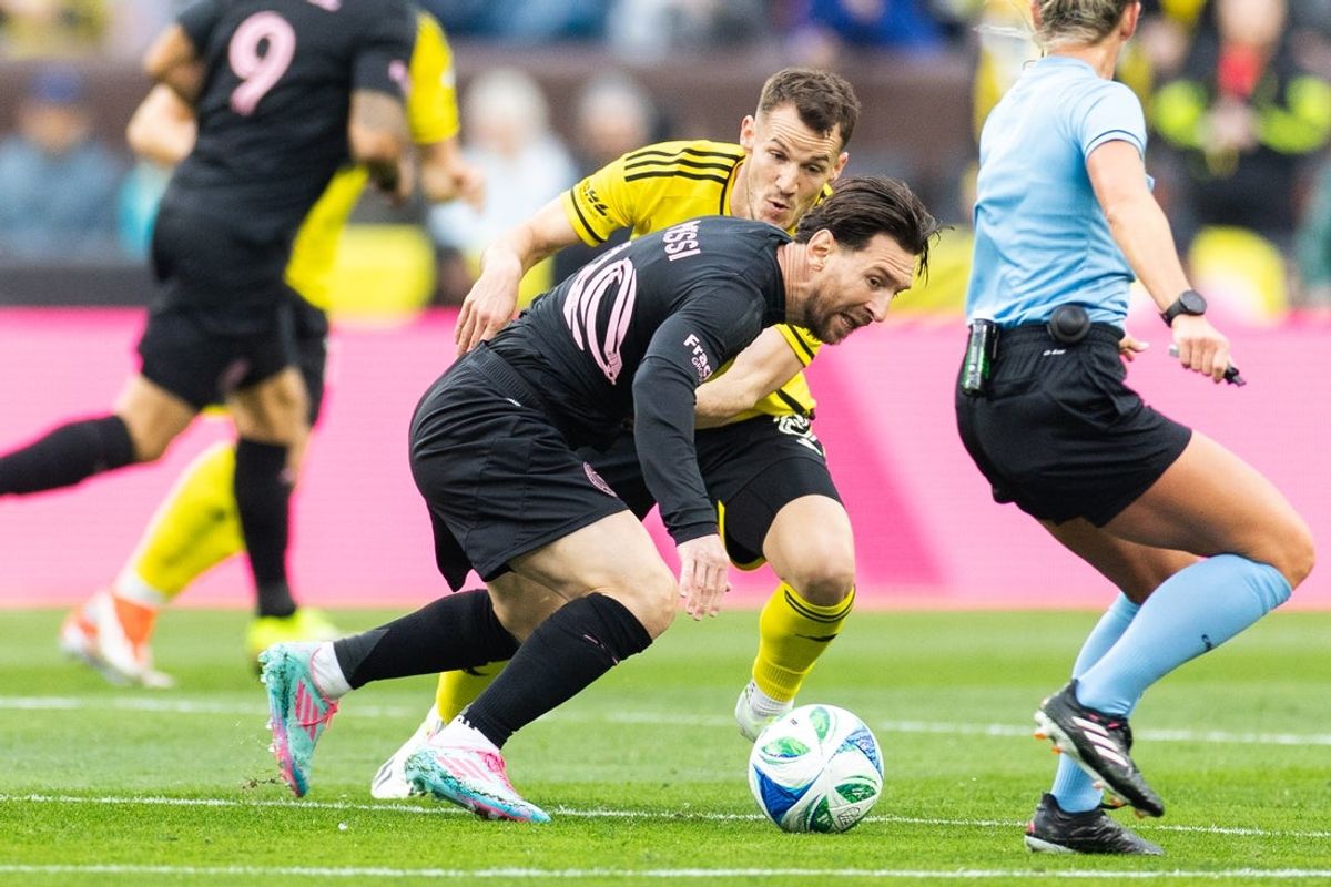 Apr 19, 2025; Cleveland, Ohio, USA; Inter Miami CF forward Lionel Messi (10) and Columbus Crew midfielder Daniel Gazdag (8) battle for the all during the first half at Huntington Bank Field. Mandatory Credit: Scott Galvin-Imagn Images