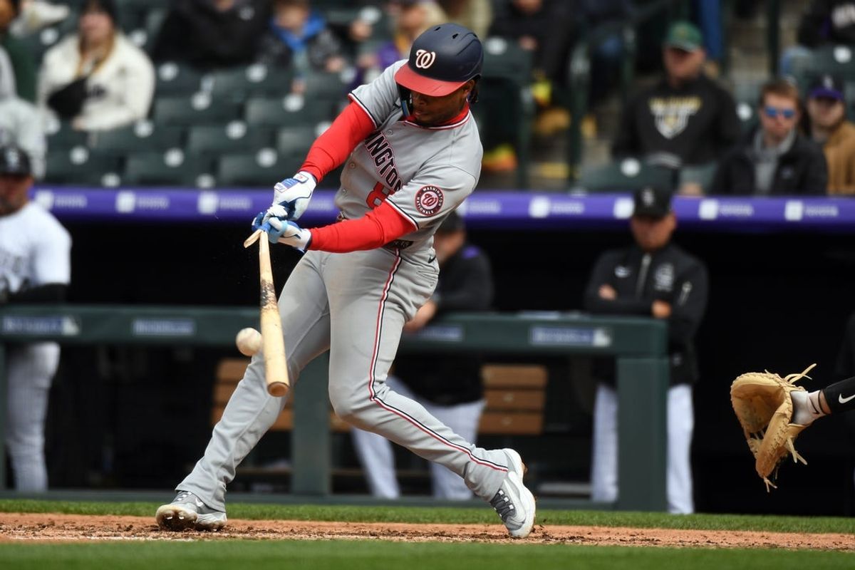 Apr 19, 2025; Denver, Colorado, USA; Washington Nationals third base Jose Tena (8) hits a broken bat RBI double during the seventh inning against the Colorado Rockies at Coors Field. Mandatory Credit: Christopher Hanewinckel-Imagn Images