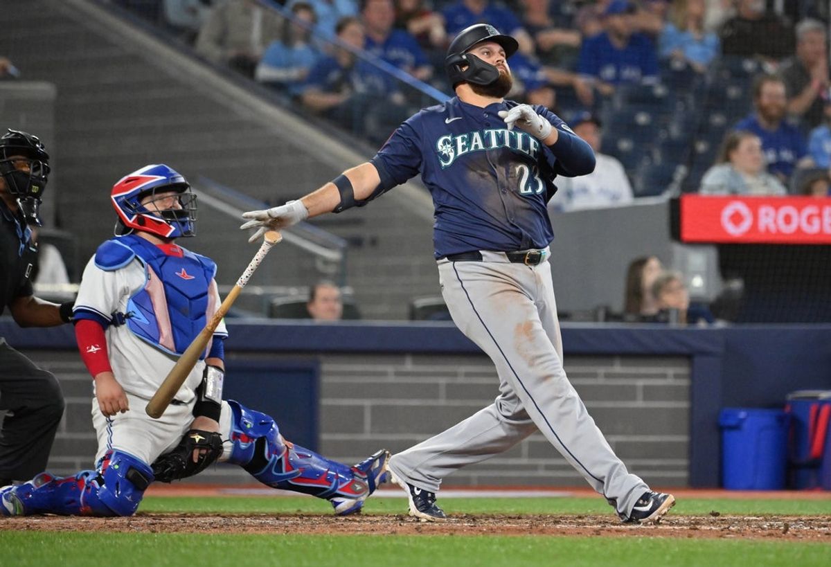 Apr 19, 2025; Toronto, Ontario, CAN;  Seattle Mariners first baseman Rowdy Tellez (23) hits a grand slam home run against the Toronto Blue Jays in the 12th inning at Rogers Centre. Mandatory Credit: Dan Hamilton-Imagn Images