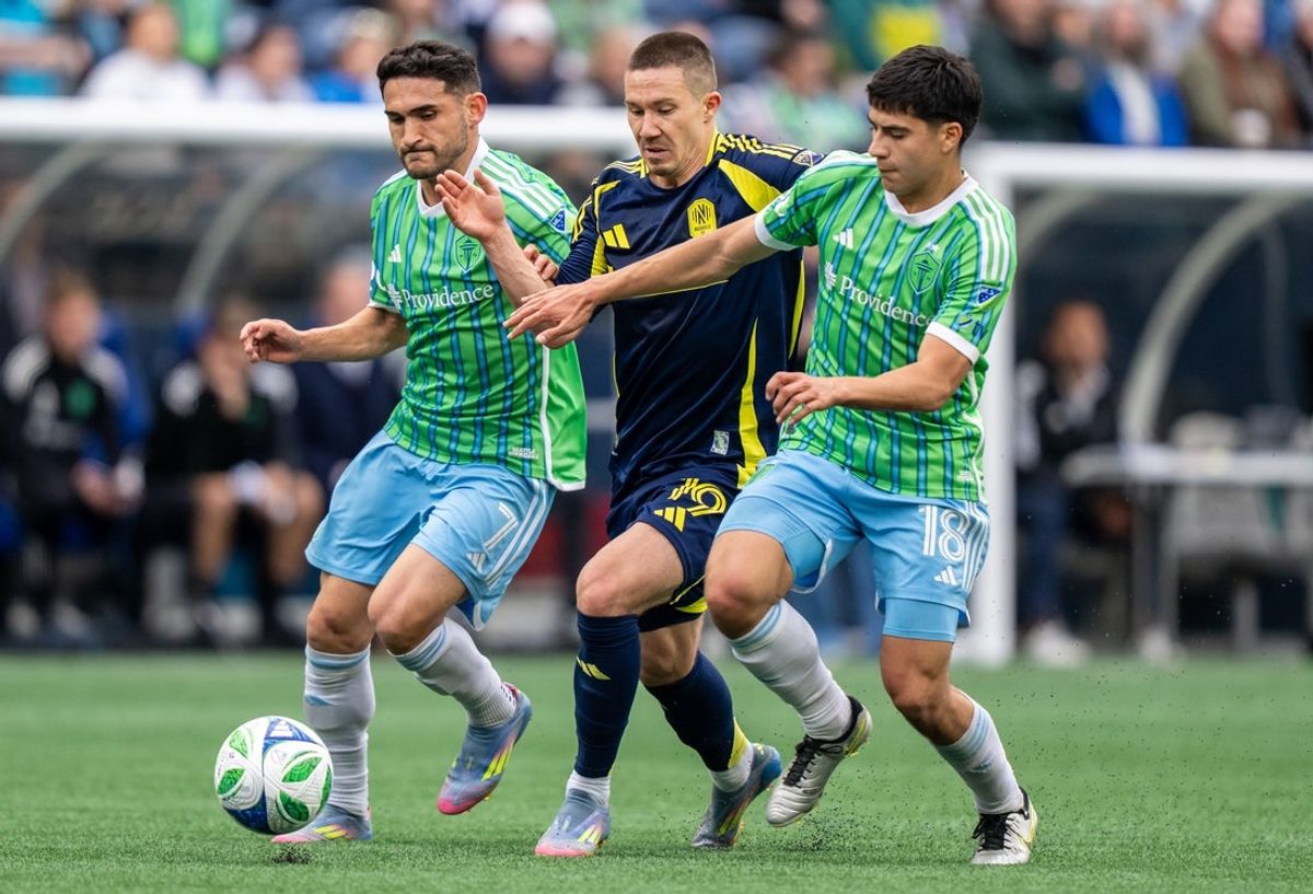 Apr 19, 2025; Seattle, Washington, USA;  Nashville SC midfielder Alex Muyl (19) battles Seattle Sounders midfielder Cristian Roldan (7) and midfielder Obed Vargas (18) for the ball during the first half at Lumen Field. Mandatory Credit: Stephen Brashear-Imagn Images