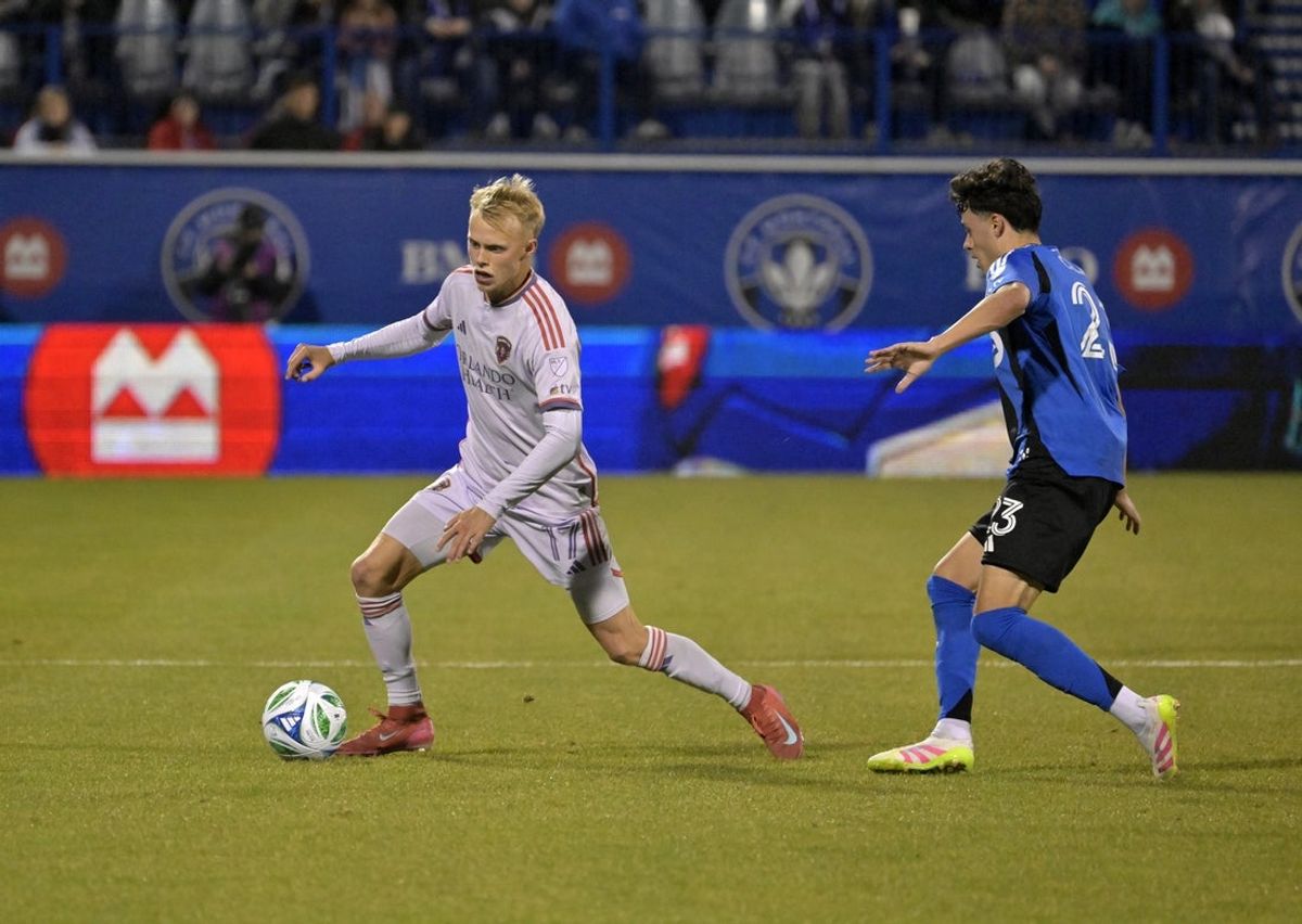 Apr 19, 2025; Montreal, Province of Quebec, CAN; Orlando City midfielder Dagur Thorhallsson (17) plays the ball as CF Montreal midfielder Caden Clark (23) defends during the second half at Saputo Stadium. Mandatory Credit: Eric Bolte-Imagn Images